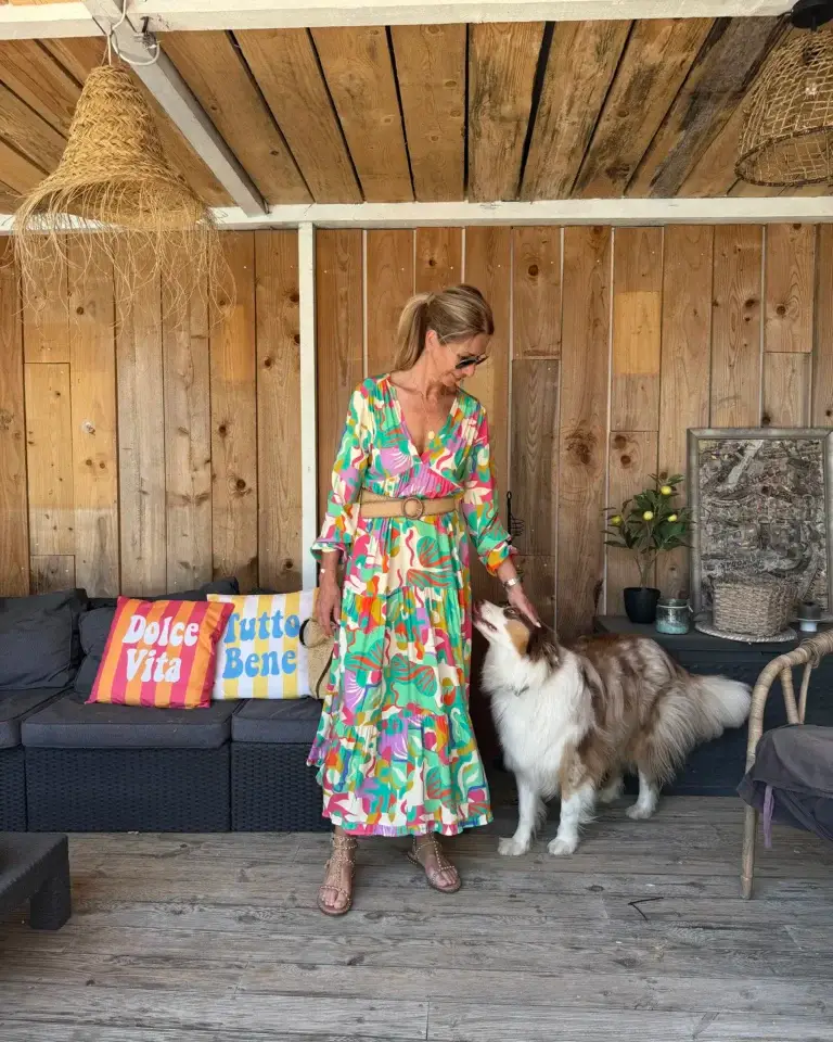 Robe longue Bella Banditas verte imprimée de motifs jaunes, rouges et roses portée par Lucie